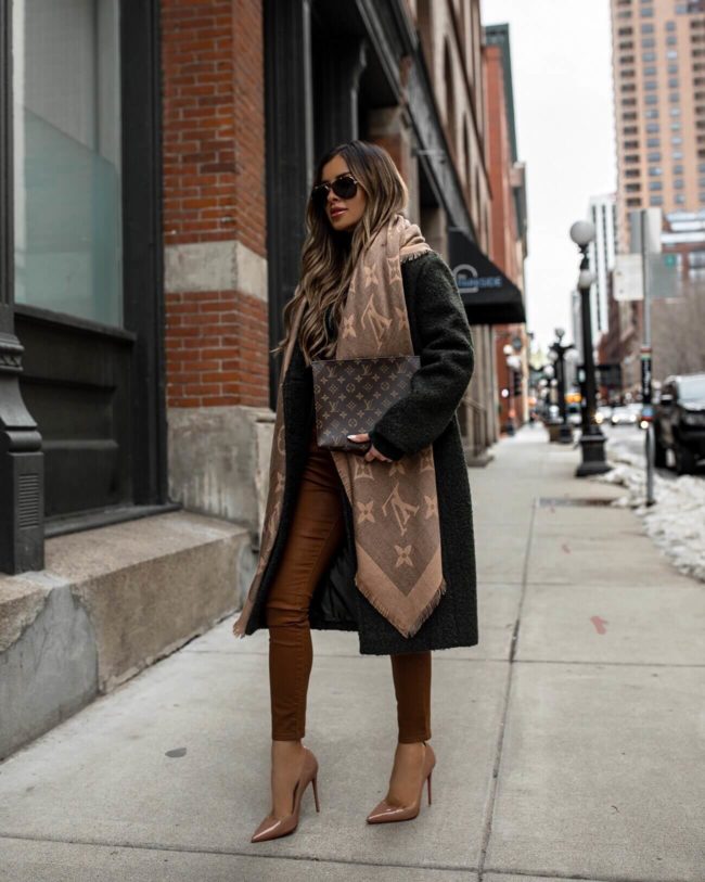 fashion blogger mia mia mine wearing coated brown denim and an olive green coat with a louis vuitton shawl