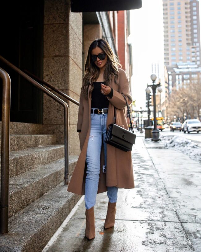 fashion blogger mia mia mine wearing a camel coat and levi's denim