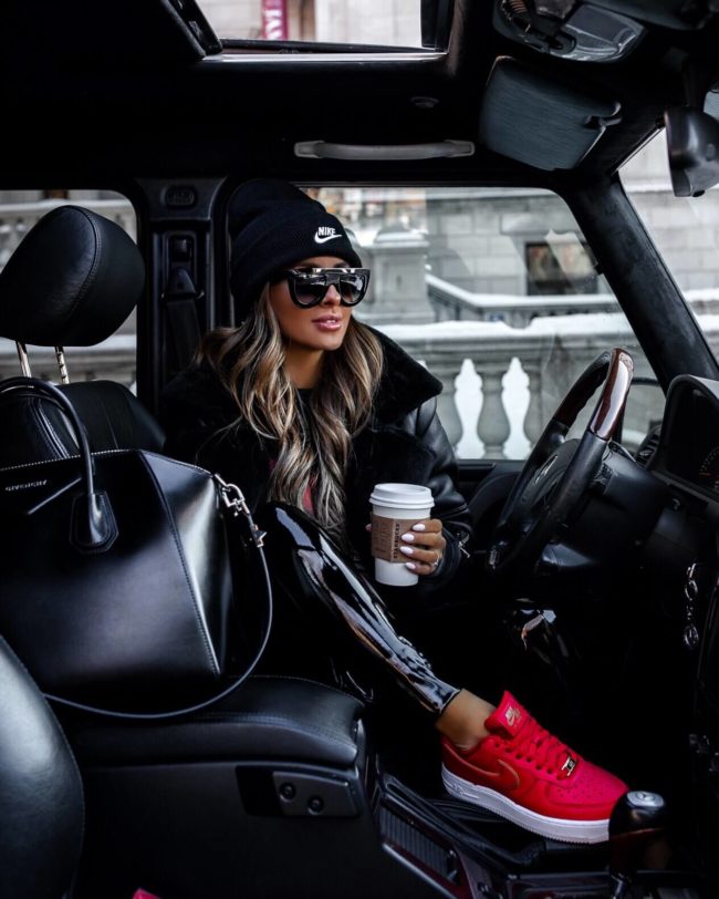 fashion blogger mia mia mine wearing red nike sneakers and a red nike beanie