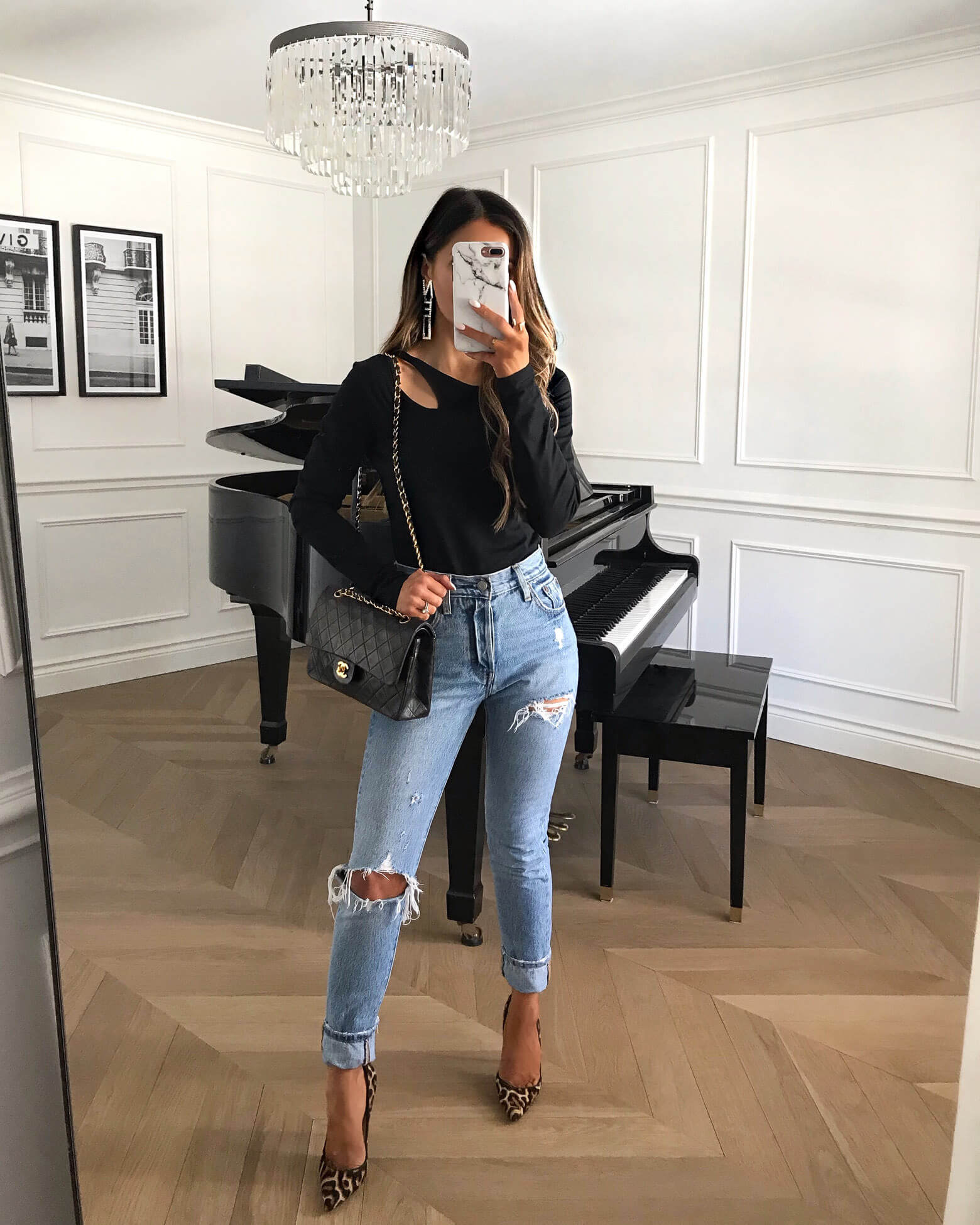fashion blogger mia mia mine wearing a black bodysuit and levi's denim 