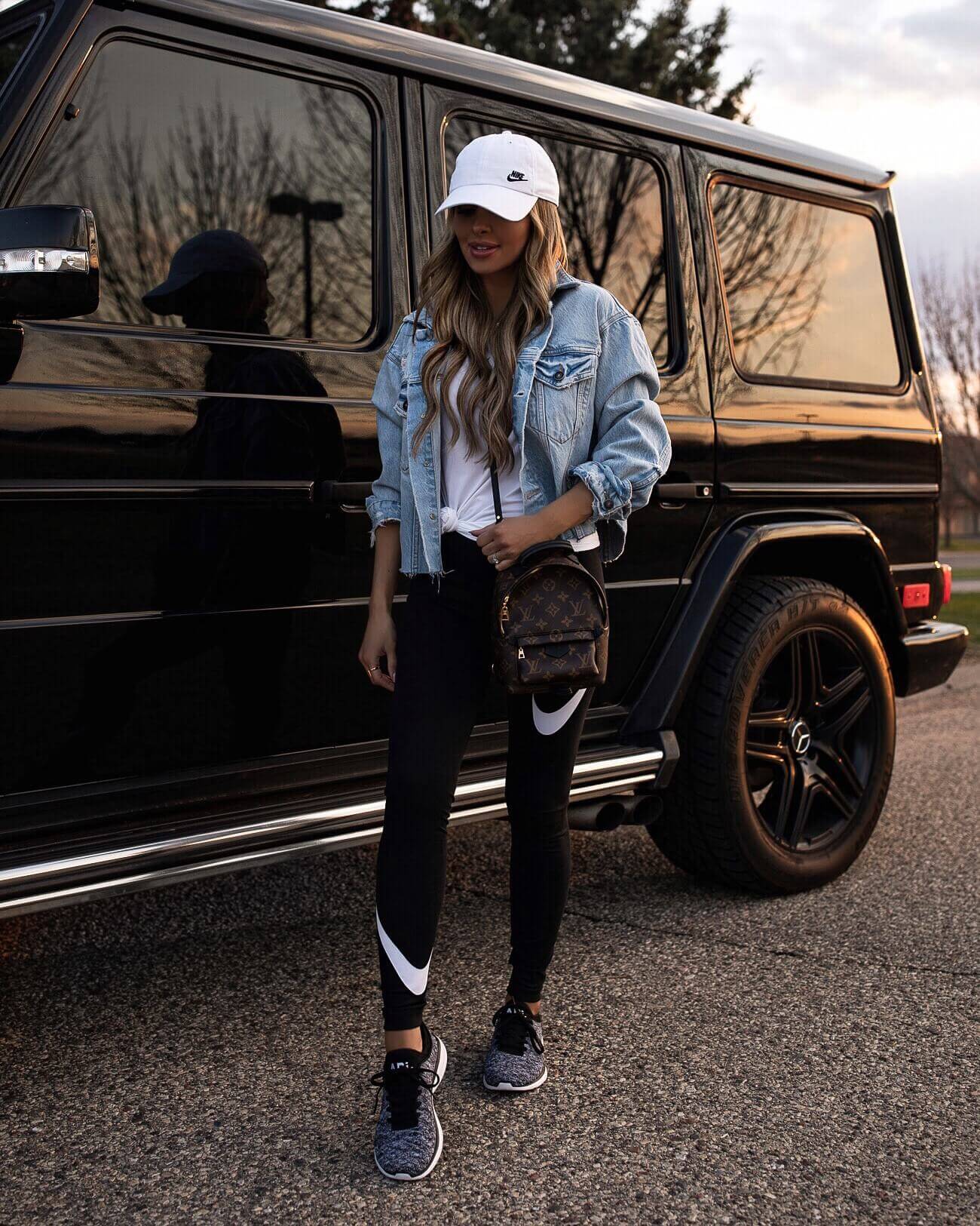 fashion blogger mia mia mine wearing nike leggings and a free people denim jacket