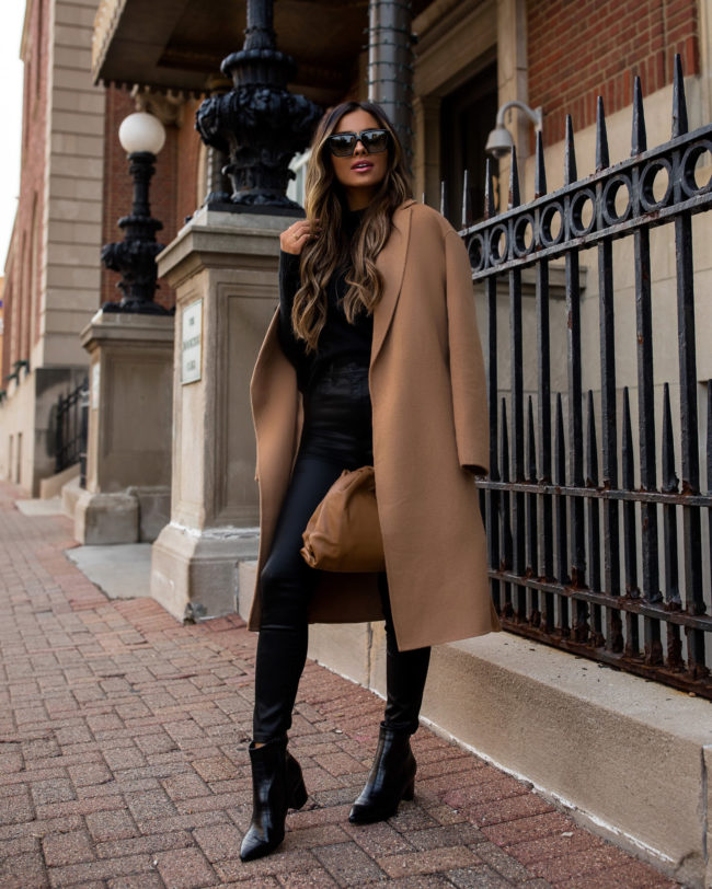 fashion blogger wearing a camel coat and black coated denim from express for fall