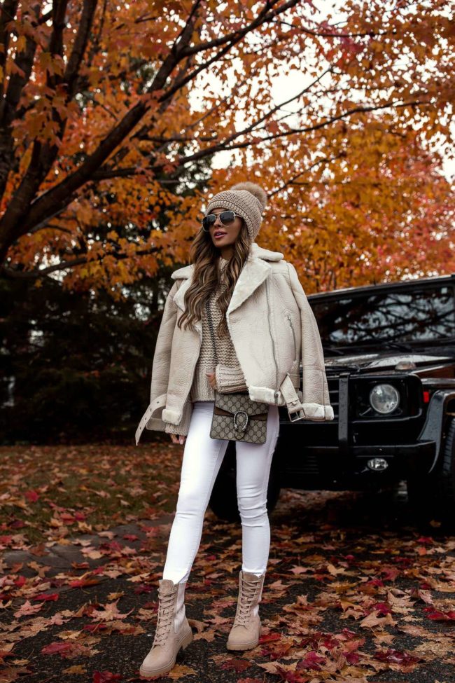 fashion blogger mia mia mine wearing a white biker jacket and beige combat boots from nordstrom