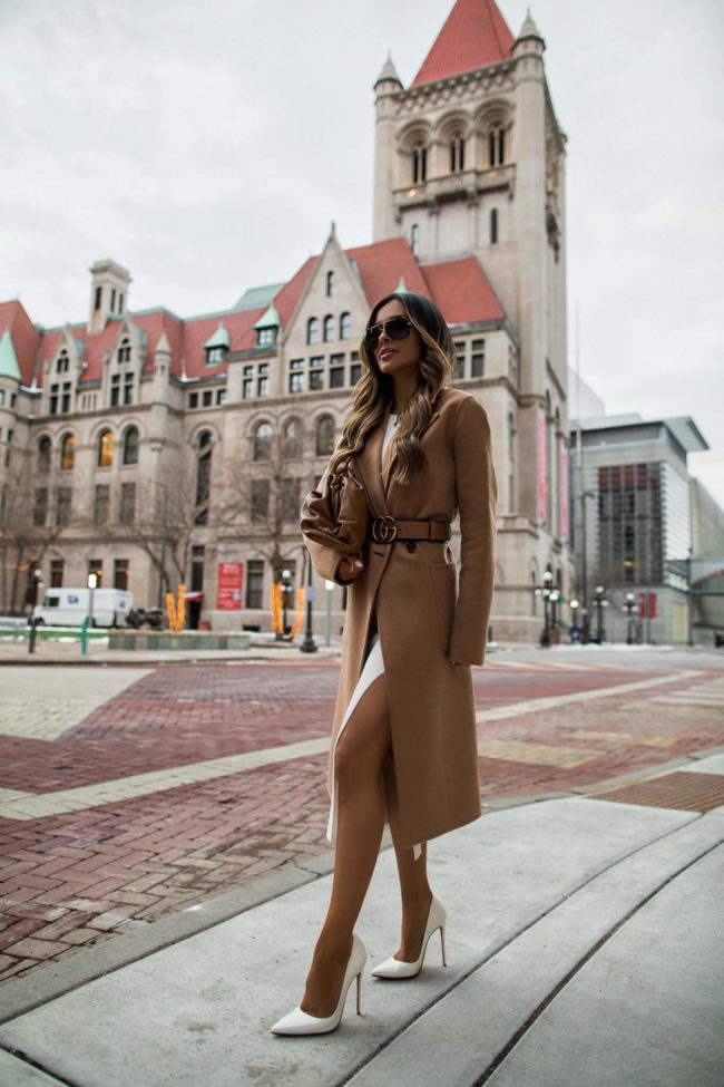 fashion blogger mia mia mine wearing a camel coat and gucci belt from cettire