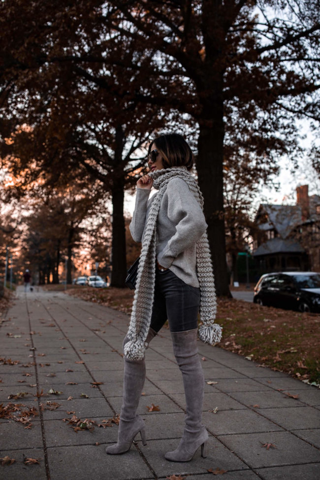 fashion blogger wearing a pom pom scarf from express
