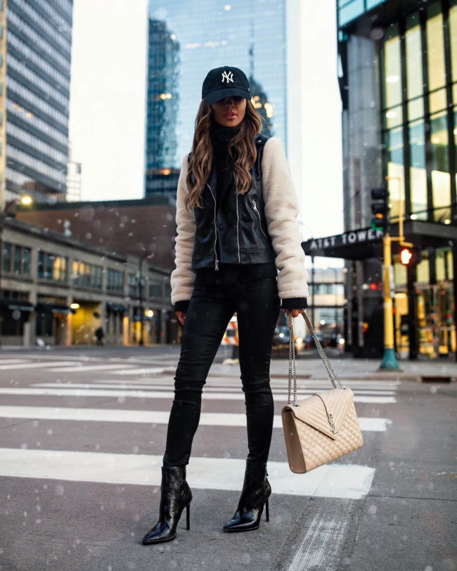 fashion blogger mia mia mine wearing a shearling moto jacket from express for black friday