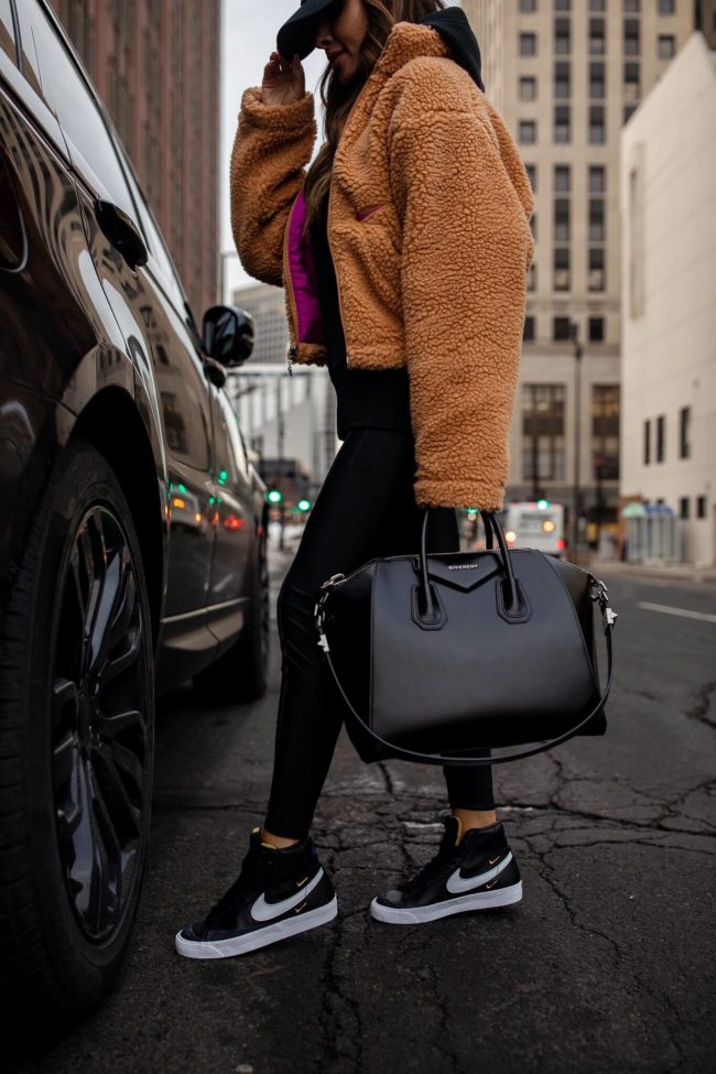 mia mia mine wearing black leather nike blazer sneakers from nordstrom
