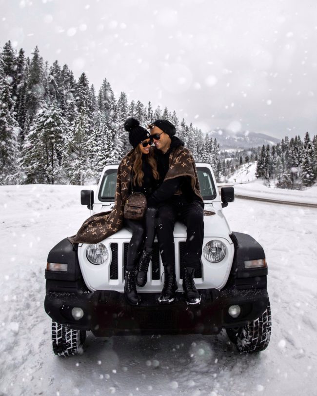 fashion blogger mia mia mine wrapped up in a louis vuitton blanket with her husband