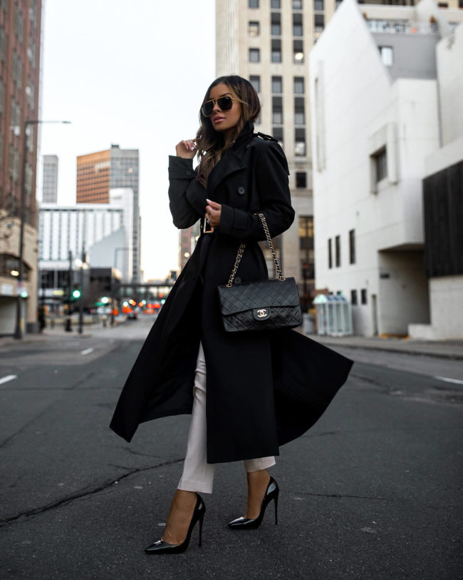 mia mia mine wearing a black trench coat by karen millen