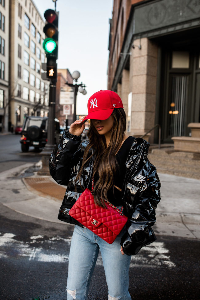 fashion blogger mia mia mine wearing a nike puffer jacket from revolve