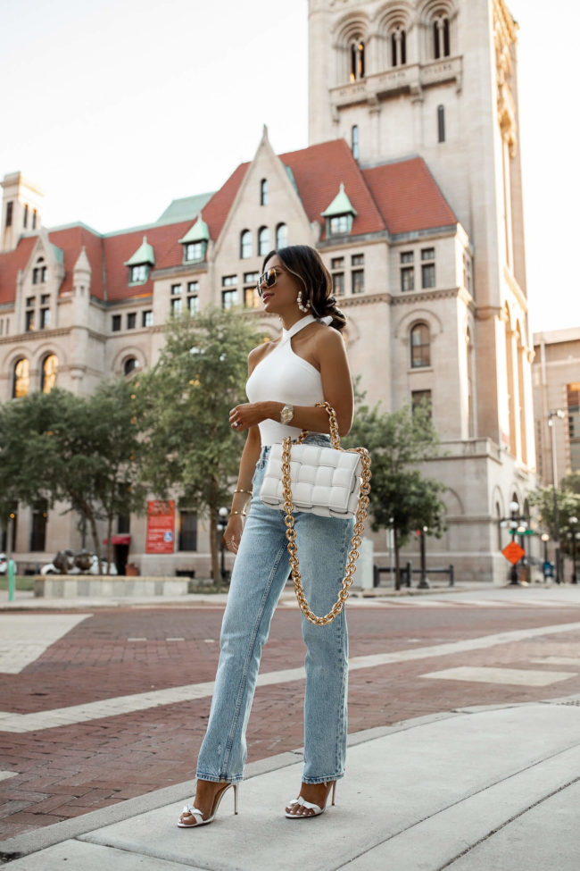 fashion blogger mia mia mine wearing a white knit bodysuit and denim from abercrombie