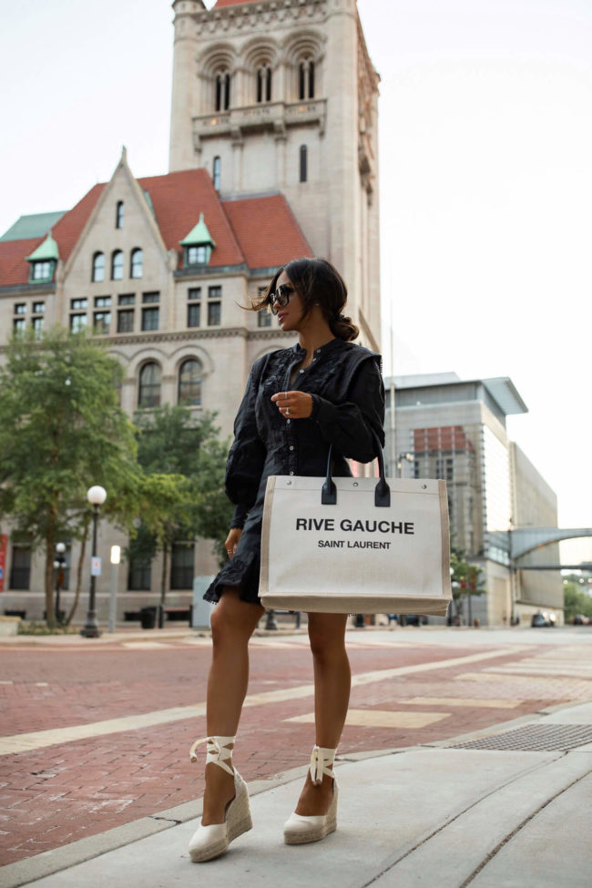 mia mia mine wearing a black dress and castaner espadrilles from saks fifth avenue