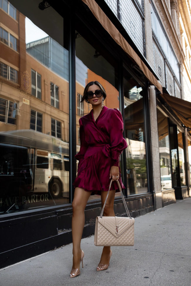 fashion blogger wearing a burgundy zimmermann dress for a fall wedding