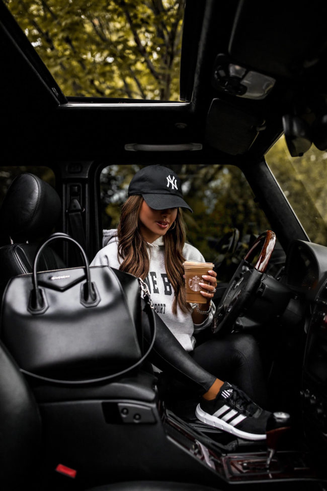 fashion blogger mia mia mine wearing adidas sneakers and an anine bing sweatshirt