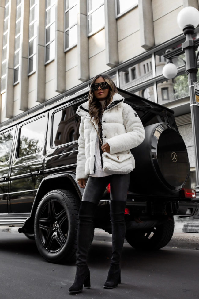 fashion blogger mia mia mine wearing a white sherpa jacket and white boucle ysl saint laurent bag