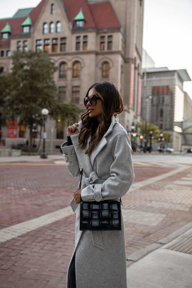 mia mia mine wearing a gray coat and black crossbody bag for fall