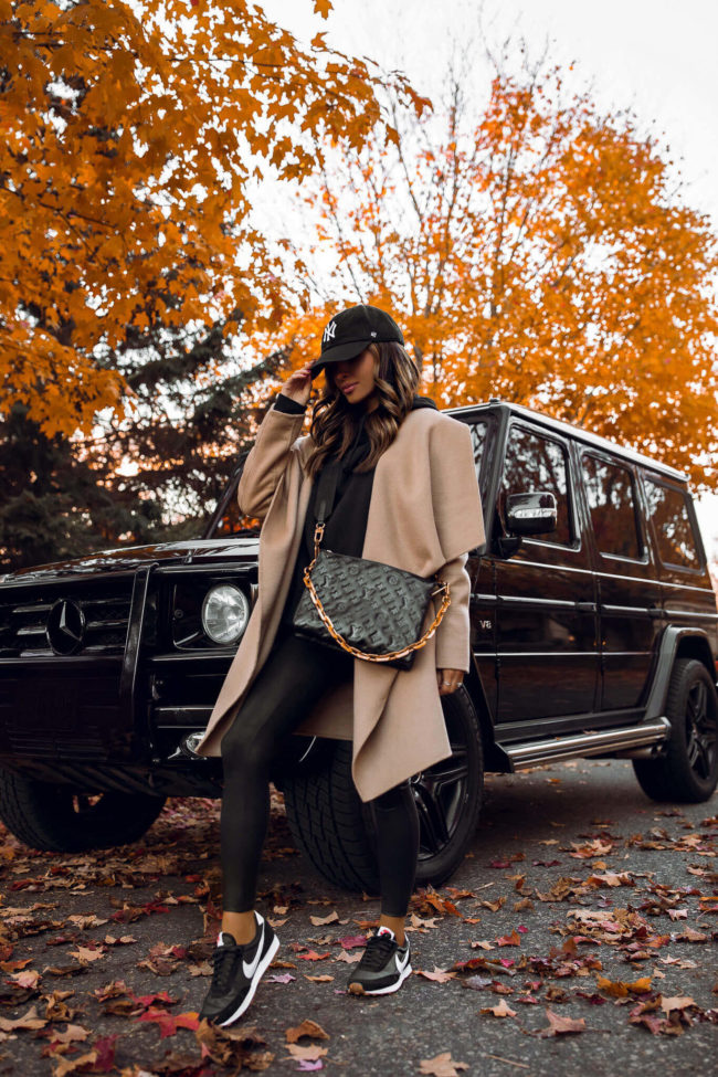 fashion blogger mia mia mine wearing a camel waterfall coat and nike daybreak sneakers