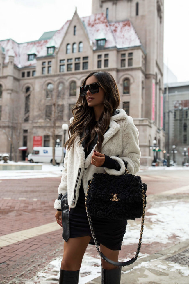 fashion blogger mia mia mine wearing a shearling moto jacket from express