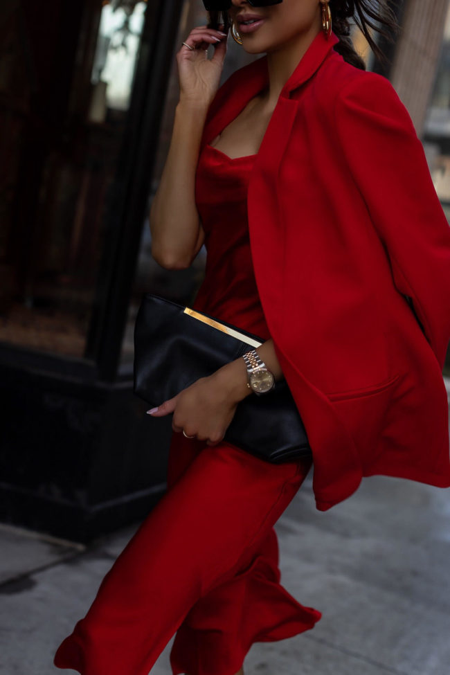 fashion blogger mia mia mine wearing a red dress and a black clutch