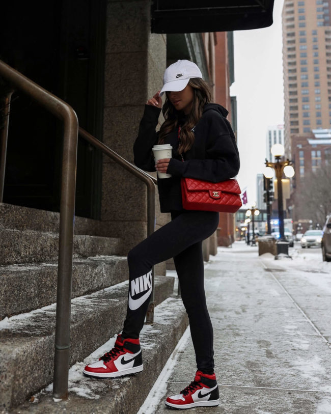 fashion blogger mia mia mine wearing nike leggings and red chanel bag