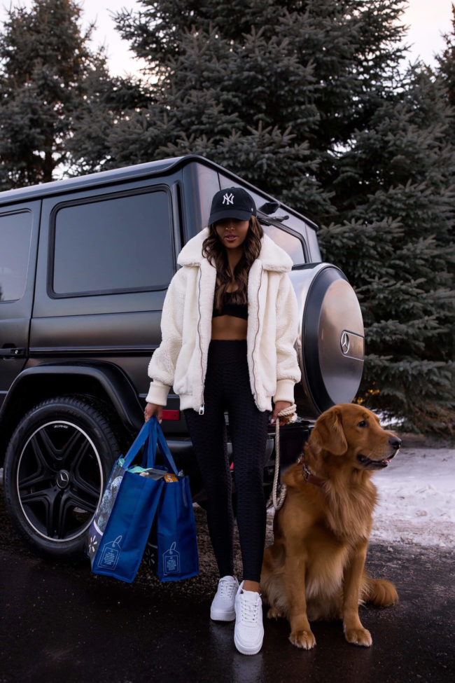 fashion blogger mia mia mine wearing a sherpa jacket and workout outfit from walmart