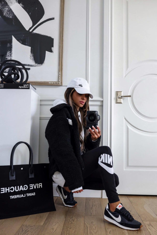 fashion blogger wearing a black nike fleece jacket from nordstrom