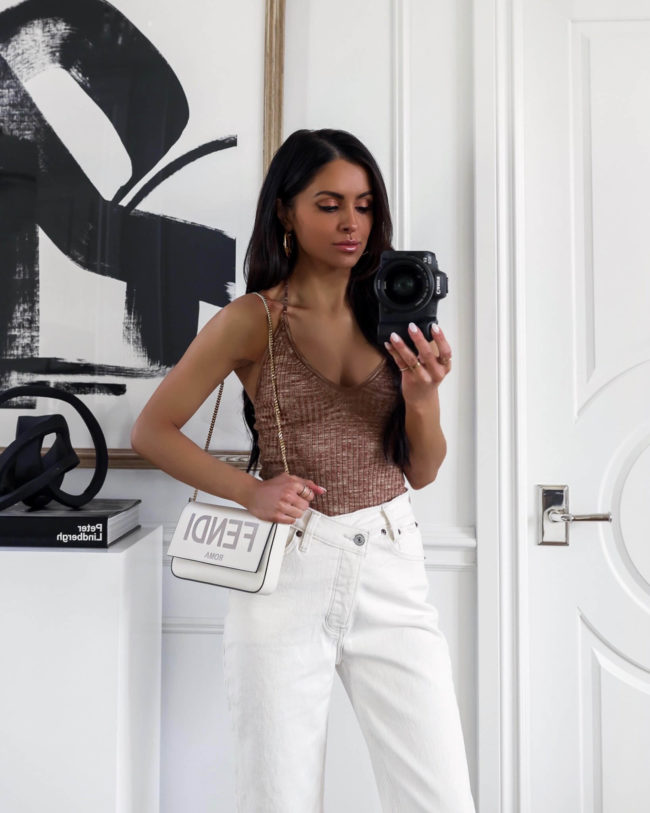 fashion blogger mia mia mine wearing white criss cross denim on sale for the LTK sale 2022 from abercrombie