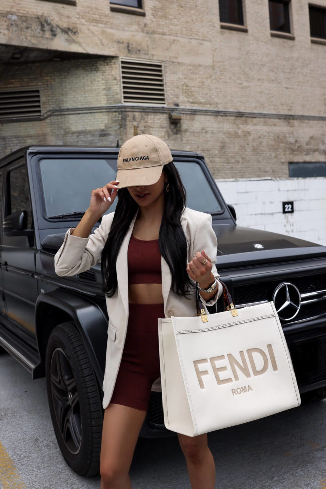 fashion blogger wearing a workout set and a blazer for summer
