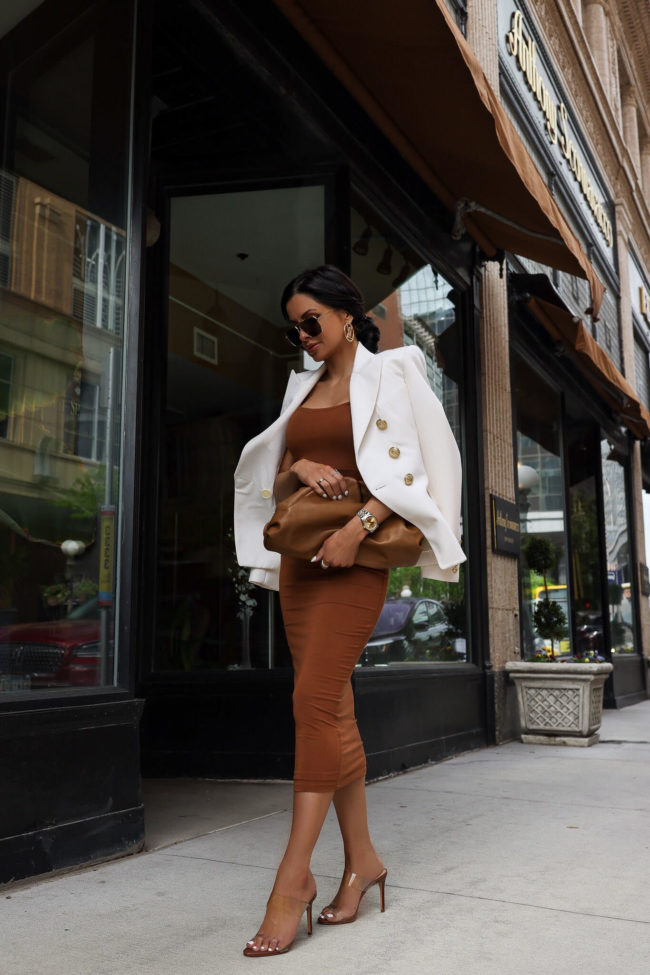 brunette woman wearing a white balmain blazer and dress for summer