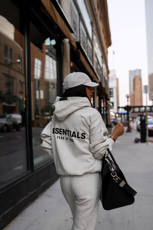 fashion blogger mia mia mine wearing an essentials fear of god sweatshirt from ssense