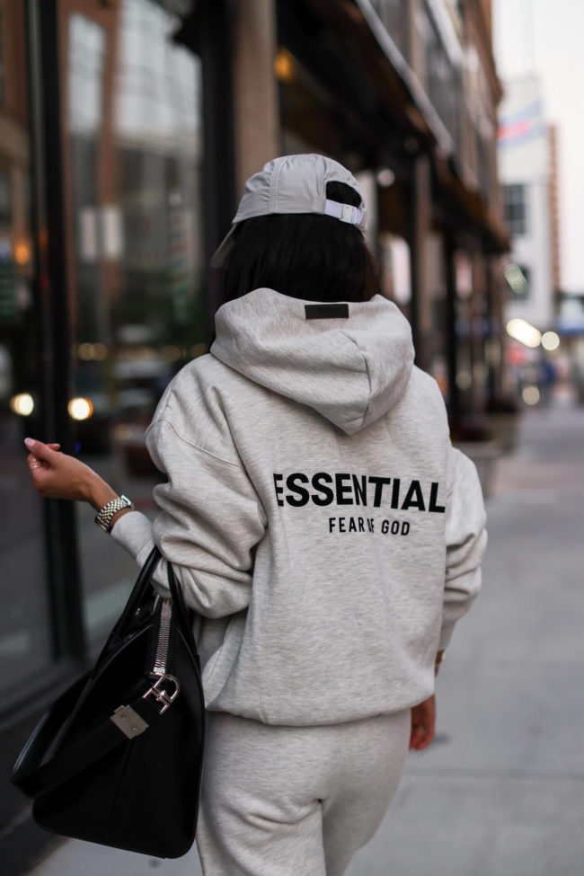 fashion blogger wearing an essentials fear of god sweatshirt
