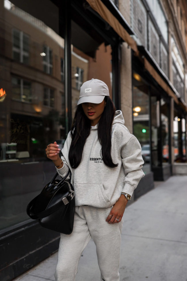 fashion blogger wearing an essentials sweatsuit from ssense