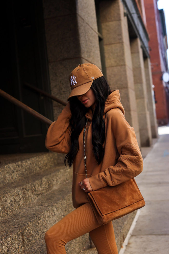 fashion blogger mia mia mine wearing a camel sweatshirt and suede bag for fall