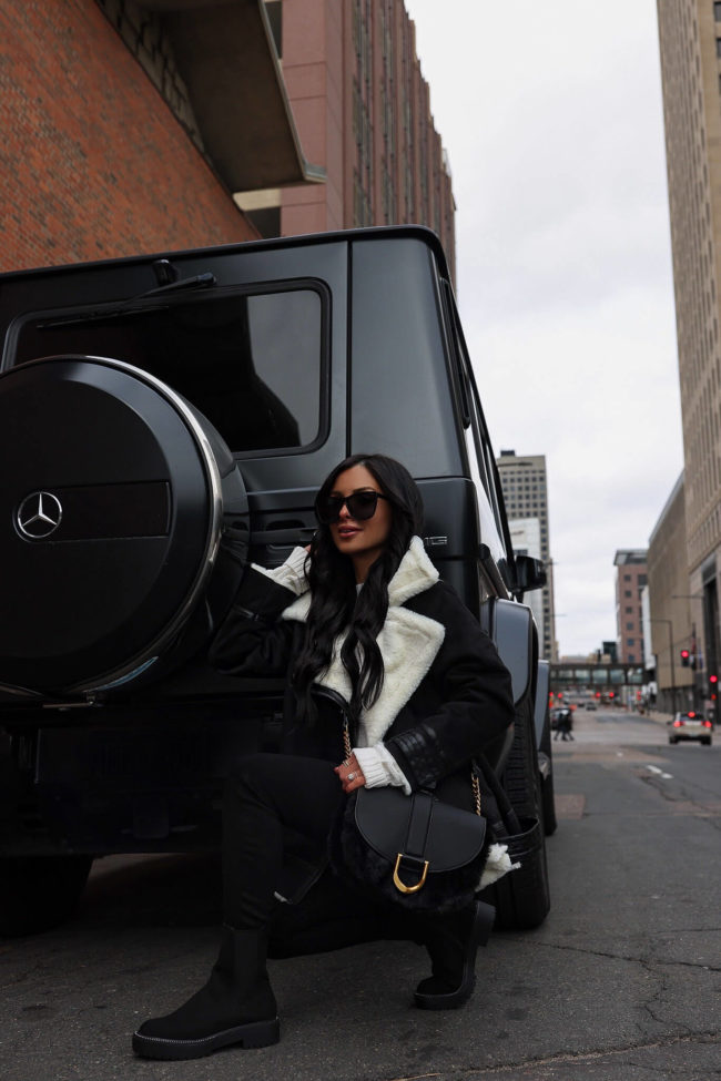 fashion blogger mia mia mine wearing a moto jacket and lug sole boots from walmart