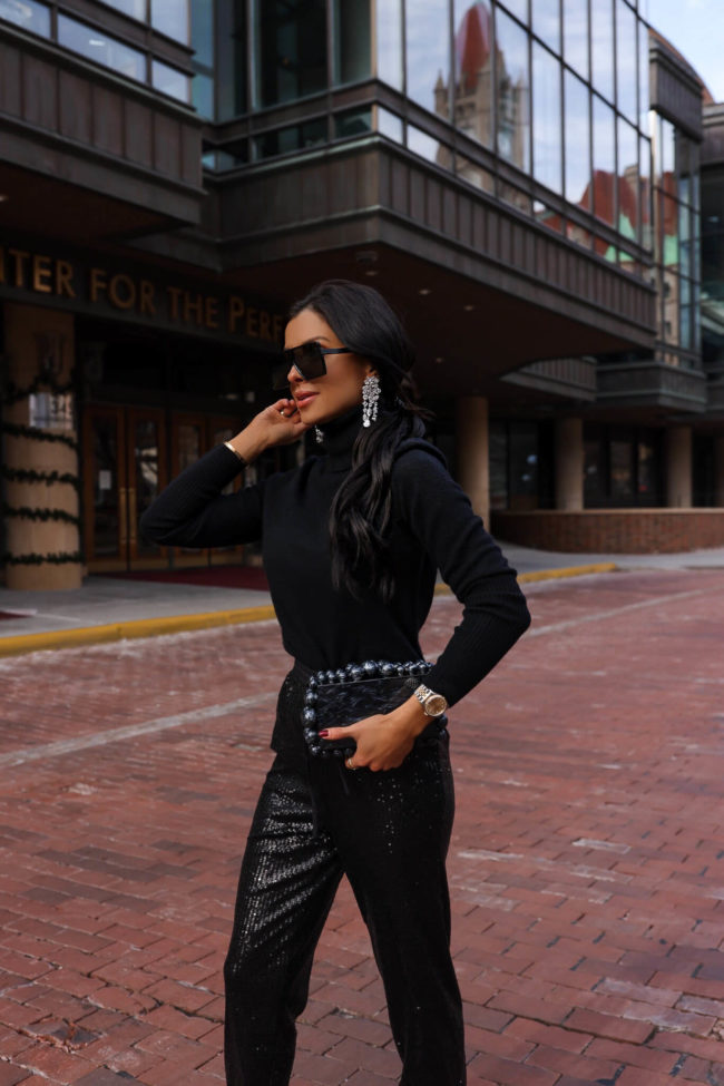 fashion blogger mia mia mine wearing a black new year's eve look from bloomingdale's