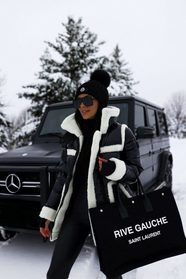 fashion blogger mia mia mine wearing a ski outfit from saks fifth avenue