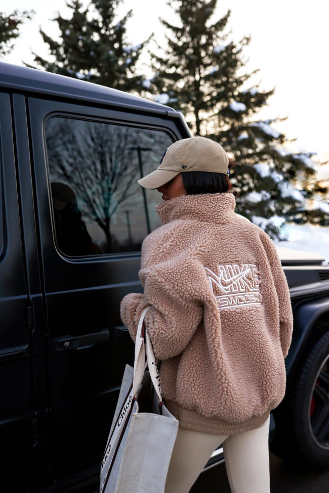 fashion blogger wearing a nike swoosh tan jacket from nordstrom