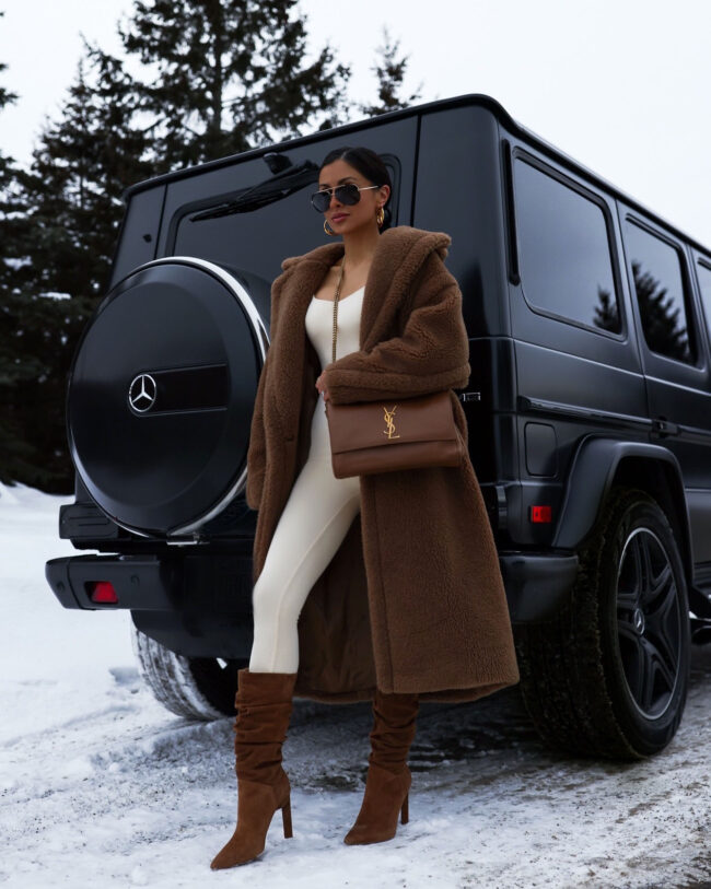 fashion blogger mia mia mine wearing a nude jumpsuit with slouchy boots