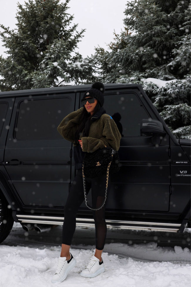 fashion blogger wearing alexander mcqueen oversize sneakers in the snow