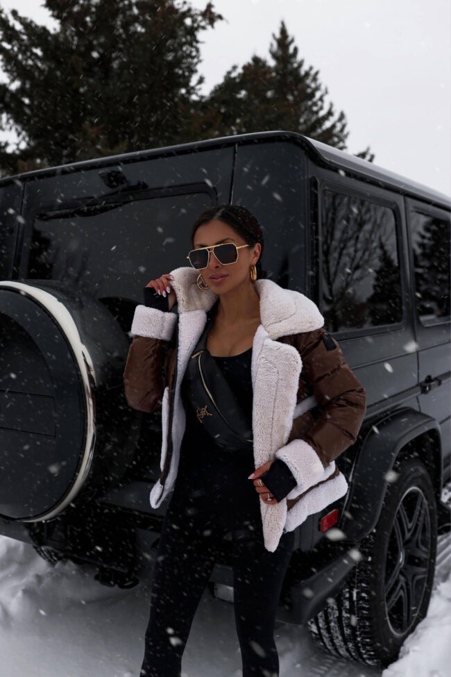fashion blogger mia mia mine wearing a shearling jacket from saks fifth avenue