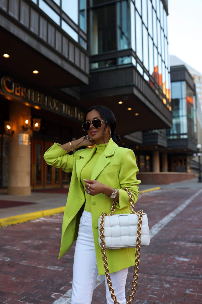 brunette fashion blogger wearing a lime green blazer and white denim for spring