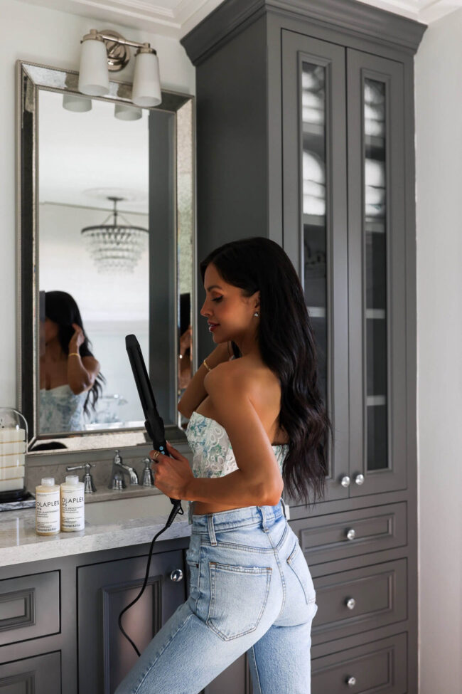 brunettte blogger using long barrel curling iron from walmart