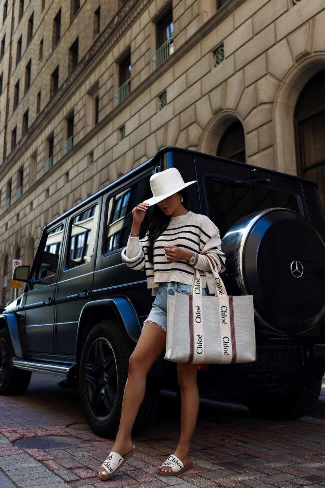 woman wearing a striped sweater and denim shorts for summer