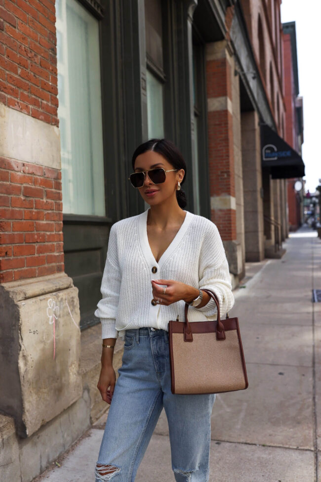 mia mia mine wearing a white cardigan and denim from walmart