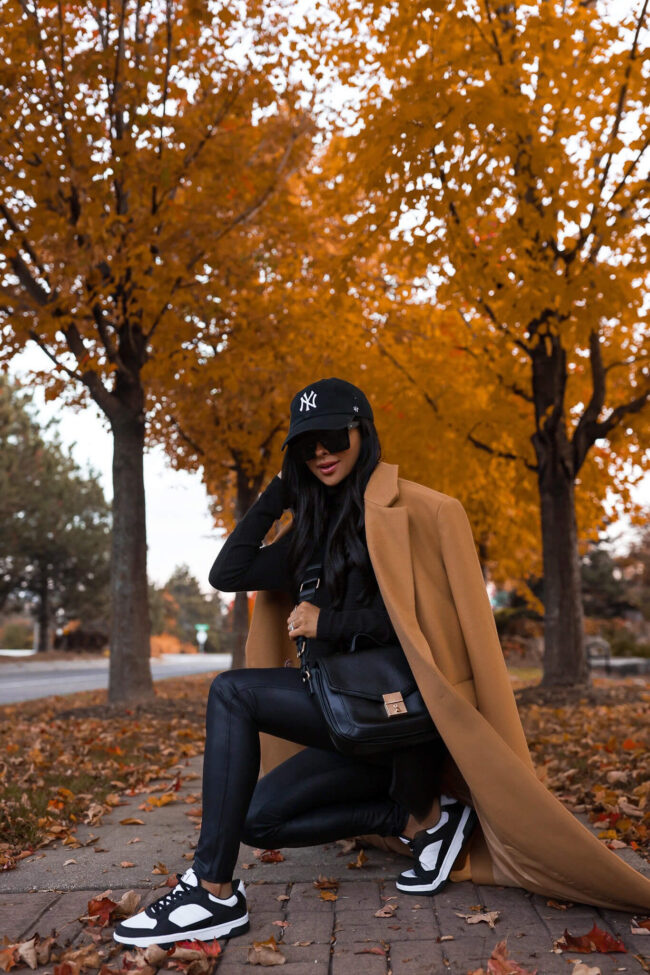 fashion blogger wearing black and white sneakers similar to Nike Dunk High from walmart