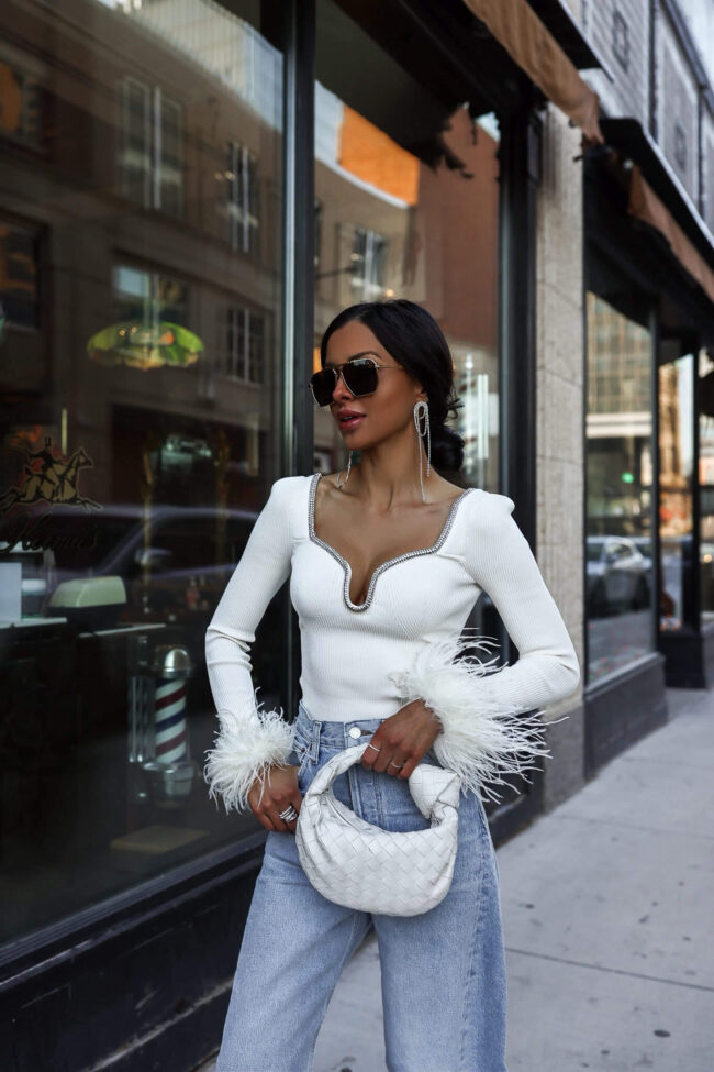 fashion blogger wearing a self-portrait white feather top from saks