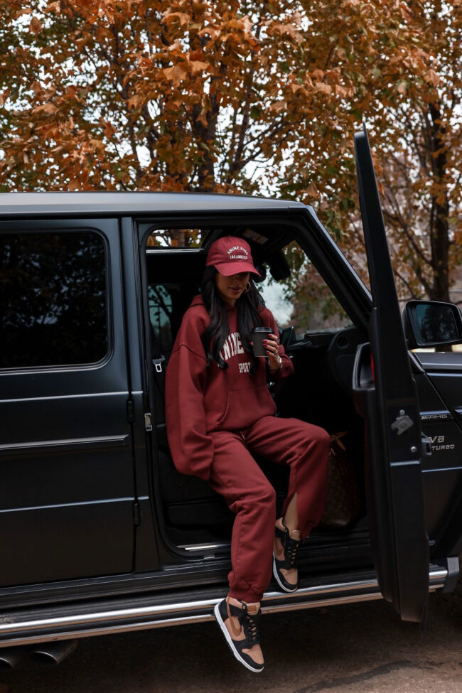 fashion blogger wearing a burgundy anine bing sweatsuit for fall