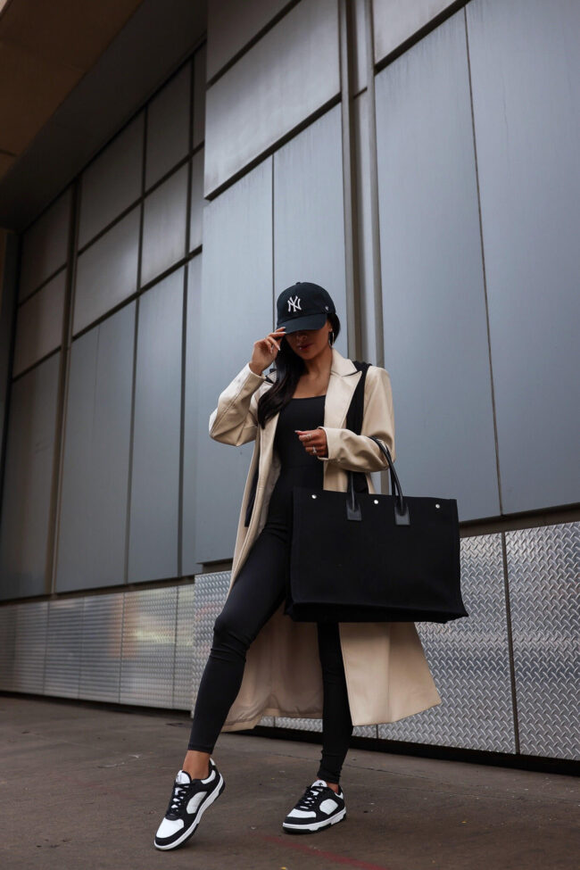 fashion blogger mia mia mine wearing a trench coat and catsuit from walmart