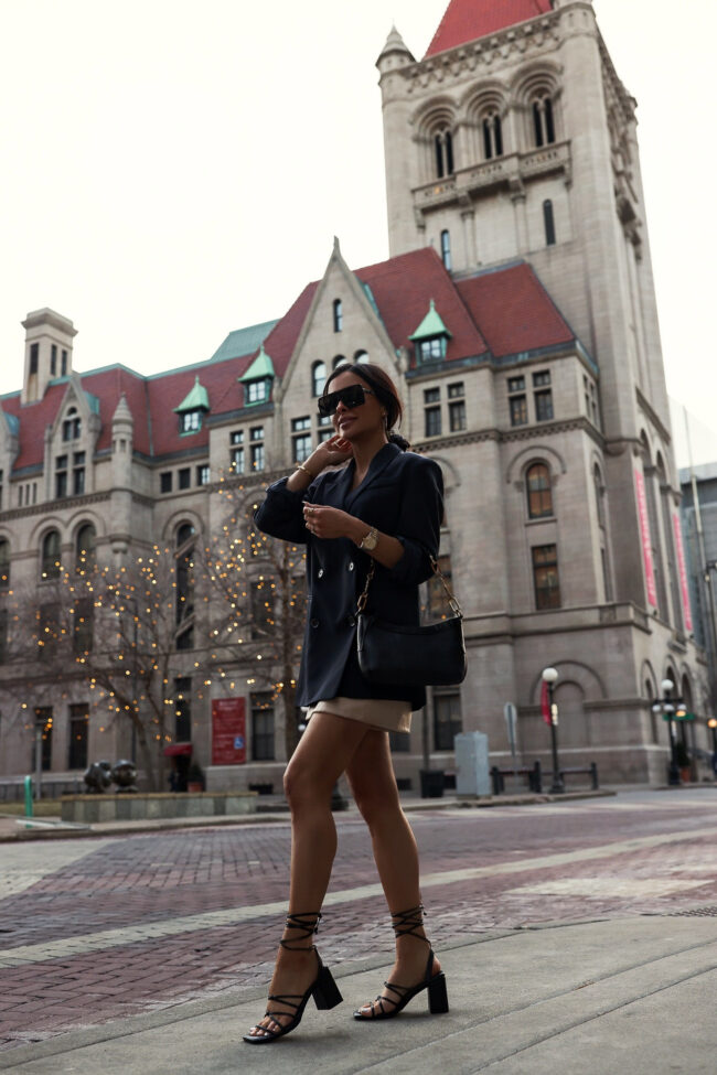 fashion blogger mia mia mine wearing a black oversized blazer and faux leather short from walmart