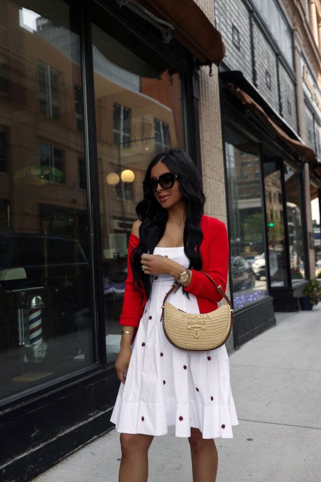 fashion blogger mia mia mine wearing a staud red cardigan